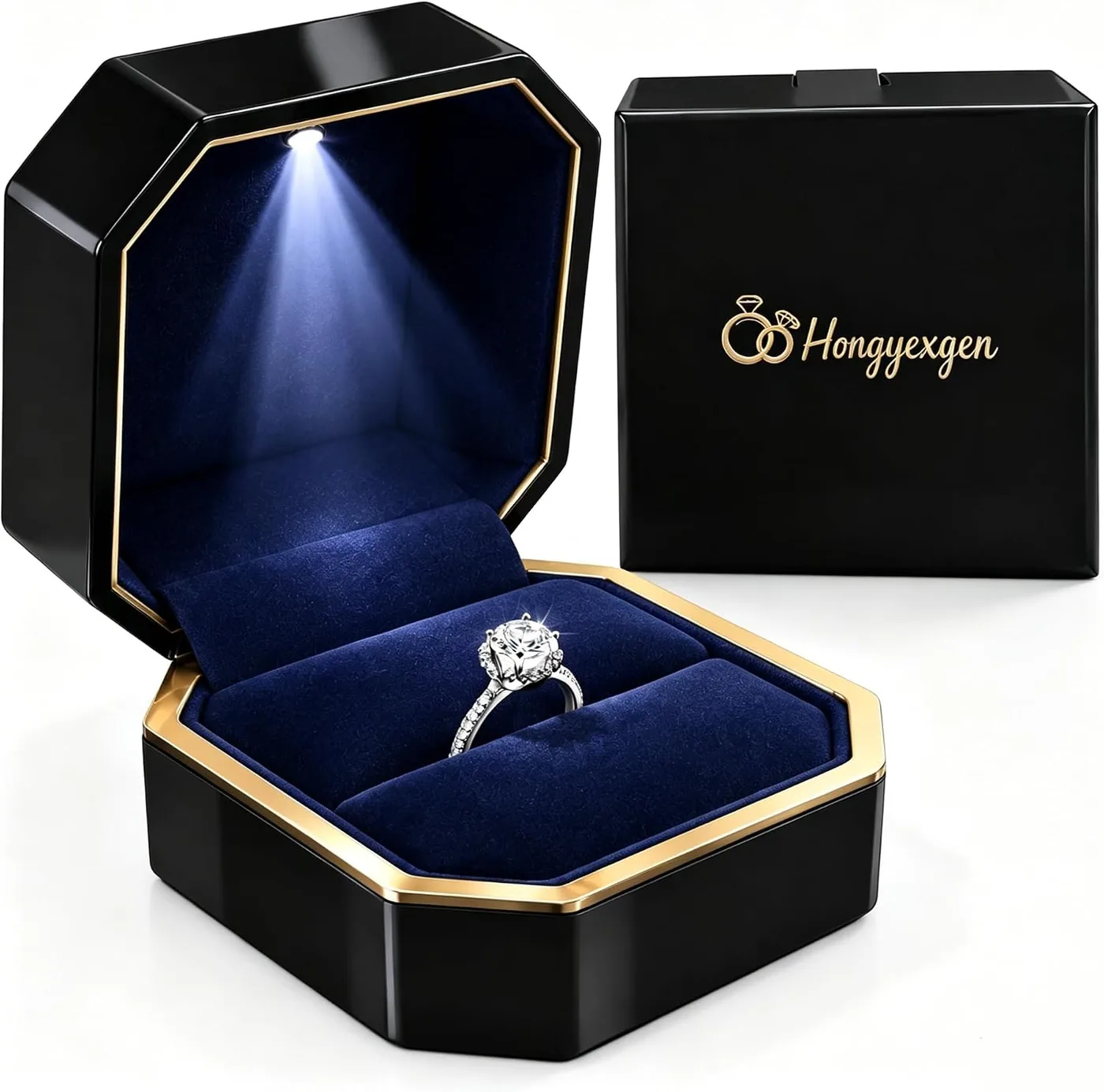 Black octagonal LED ring box open with the lid light on, a ring in the blue insert, and the closed lid beside it
